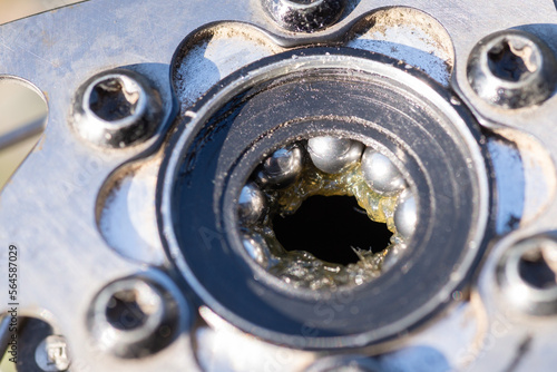 Close up of bearings inside bike freehub. Repairing bicycle on fresh air in sunny weather, renewing the vehicle photo