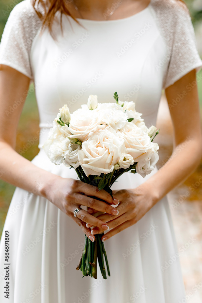 wedding bouquet in the hands of the bride close-up
