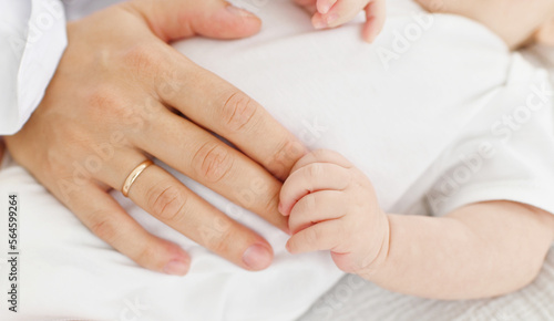 Mother with her newborn baby care hands