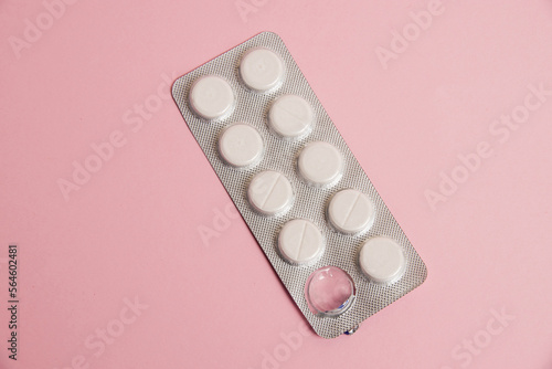 Opened blister pack with pills on a pink background. Concept of treatment of chronic diseases