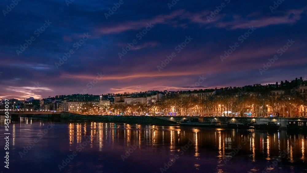 night view of Lyon city over the Saône at sunset time
