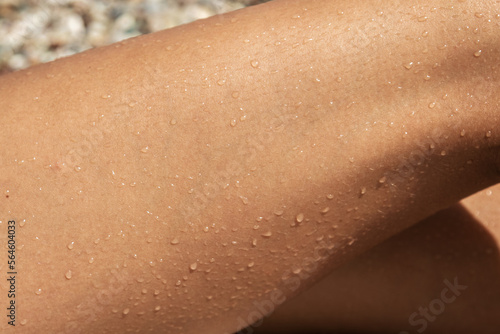 Closeup of wet tanned female skin