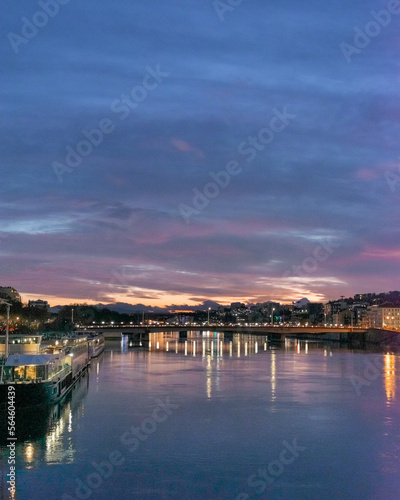 night view of a bridge in Lyon city over the Saône at sunset time