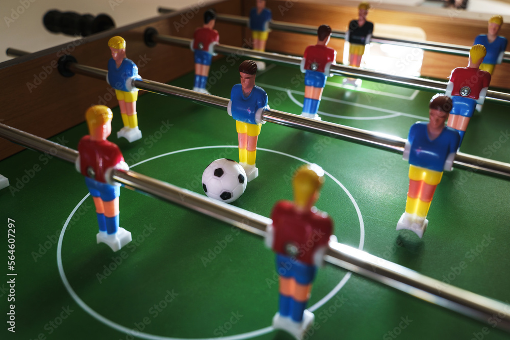 Table football game in progress creates a sense of excitement and competition Table football game in progress creates a sense of excitement and competition