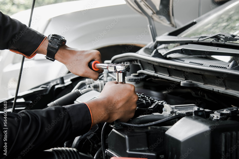 Mechanic fixing a car at home. Repair and service.