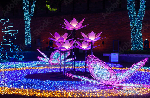 Beautiful New Year 2023 decoration. Neon lotuses in front of Tha Pae Gate in Chiang Mai, Thailand. photo