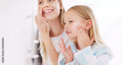 Skincare, mother and daughter home spa day washing their face in bathroom or apply beauty product, lotion or face mask while bonding at home. Happy woman and girl child doing morning skin routine