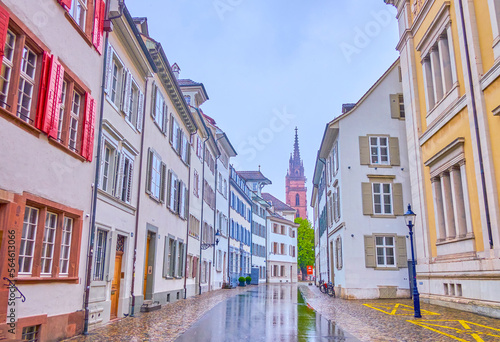 Walk on Augustinergasse street, passing historical residential buildings with Basler Munster on background, Switzerland photo