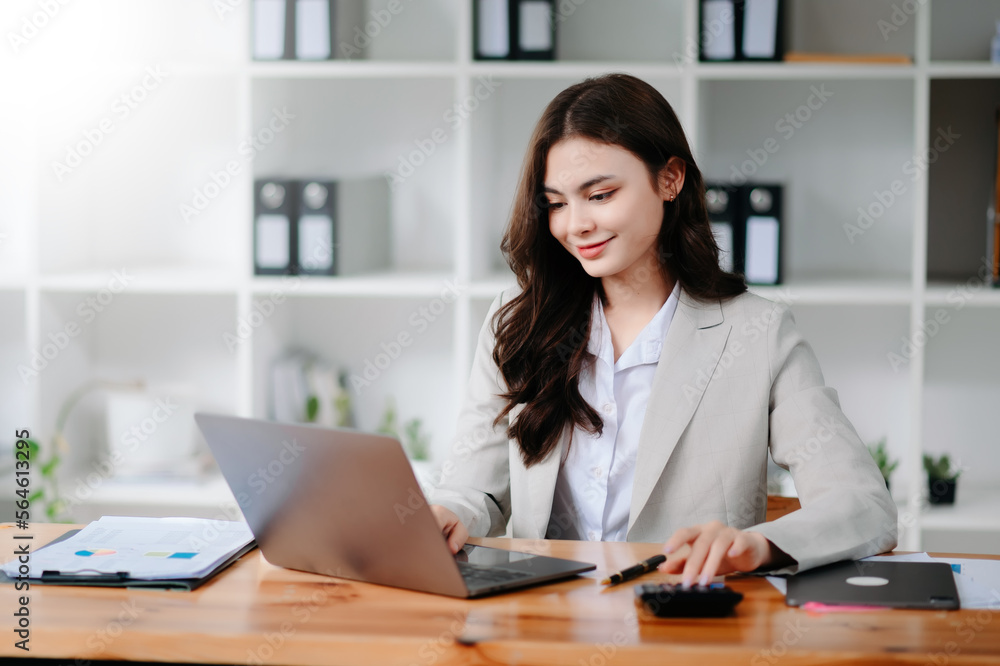 businesswoman or accountant hand typing laptop working to calculate on desk about cost at home office... businesswoman or accountant hand typing laptop working to calculate on desk about cost at home office...