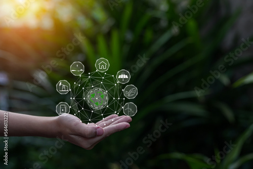 Technology  hand holding with environment Icons over the Network connection on green background.