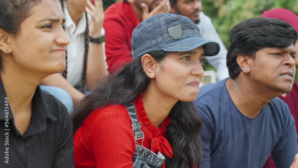 sad girl crying while watching sports match at stadium due to loss of game - concept of emotional, hope and beliefs.