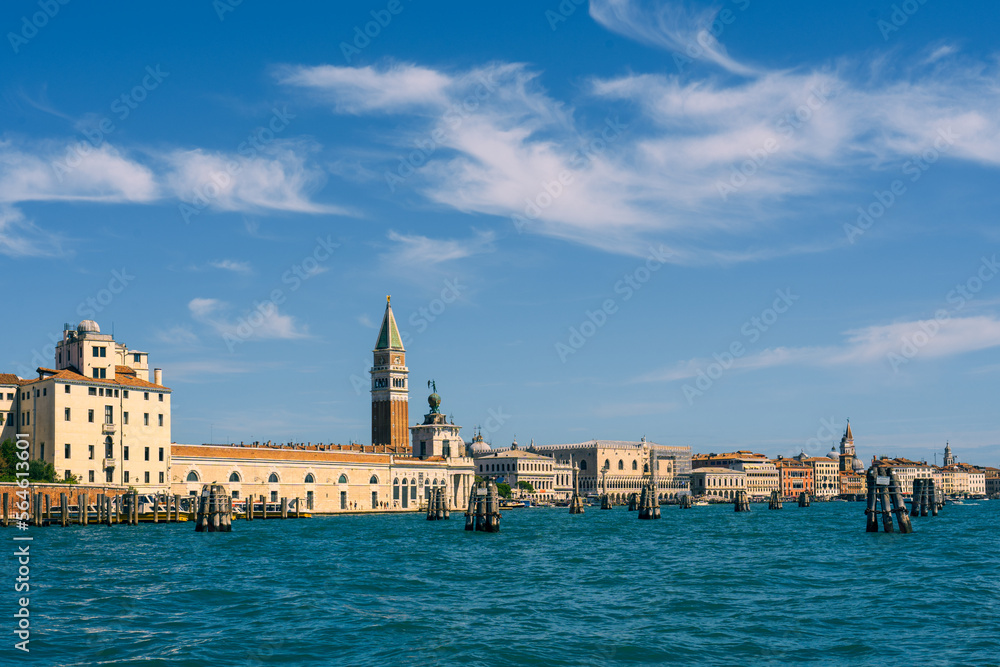 Real old houses of Venice along the sea on the Grand Canal street, a beautiful view of St. Mark's Square from the water on a sunny day, the main sea street of Venice, holidays and travel in Italy