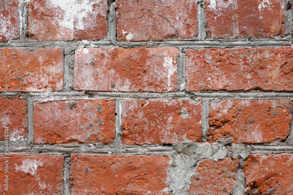 Fototapeta premium Red brick wall texture. Old facade of a building with concrete joints, vintage background