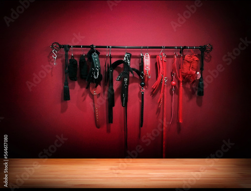 Photo Whips for BDSM on red background in darkside