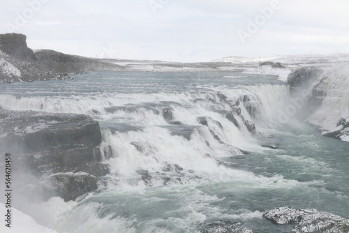 Winter landscape of a waterfall in Iceland. The area is covered with snow.