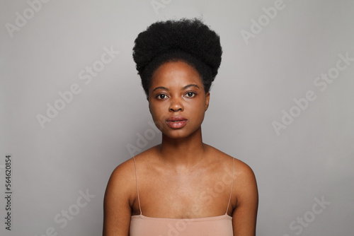  Young lady beautiful female model with fresh clean dark skin on white studio wall background. Beauty, facial treatment, skin care and wellness concept