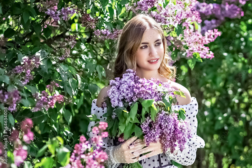 Portrait of a smiling young girl in blooming lilac trees. Summer time,vacation Portrait of a smiling young girl in blooming lilac trees. Summer time,vacation