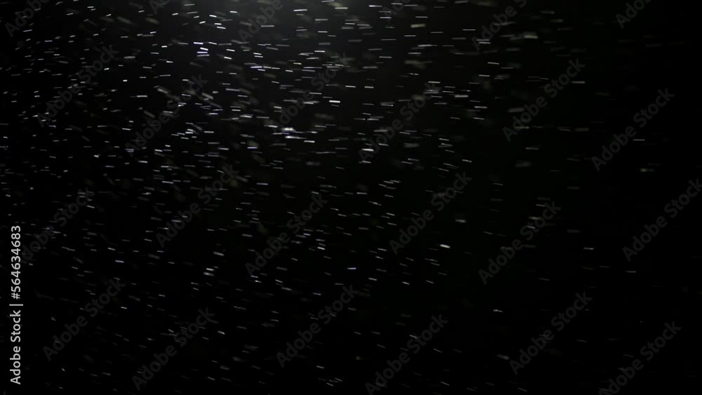Snowflakes fly slowly in front of the camera. Snow illuminated at night by the light of a lantern. Recorded in slow motion. Snowflakes fly slowly in front of the camera. Snow illuminated at night by the light of a lantern. Recorded in slow motion.