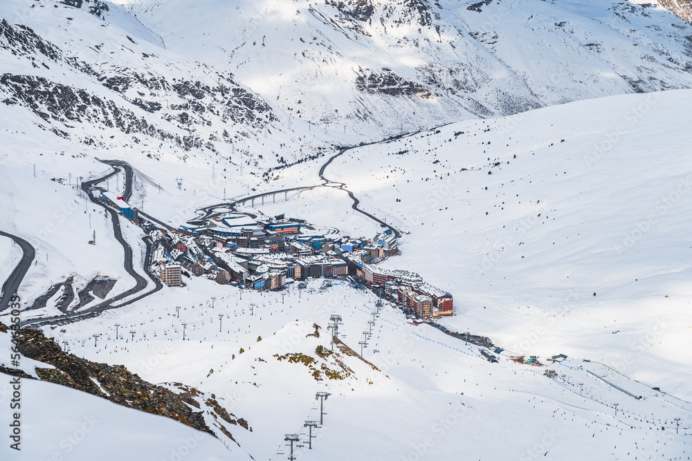 Roads going and out Pas de la Casa town in the valley between snow capped mountains. Ski winter holidays in Andorra, Pyrenees, Grandvalira