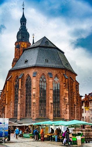 Lovely view of the famous church Heiliggeistkirche, the largest church in Heidelberg, Germany. With the apse facing the market square, it stands in the middle of Heidelberg's old town. photo