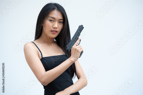 Fotografie, Obraz Sexy beauty young woman in black camisole posing with gun on white background