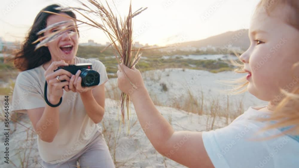 Family photographer. Woman with camera takes picture of the toddler girl outdoor Family photographer. Woman with camera takes picture of the toddler girl outdoor