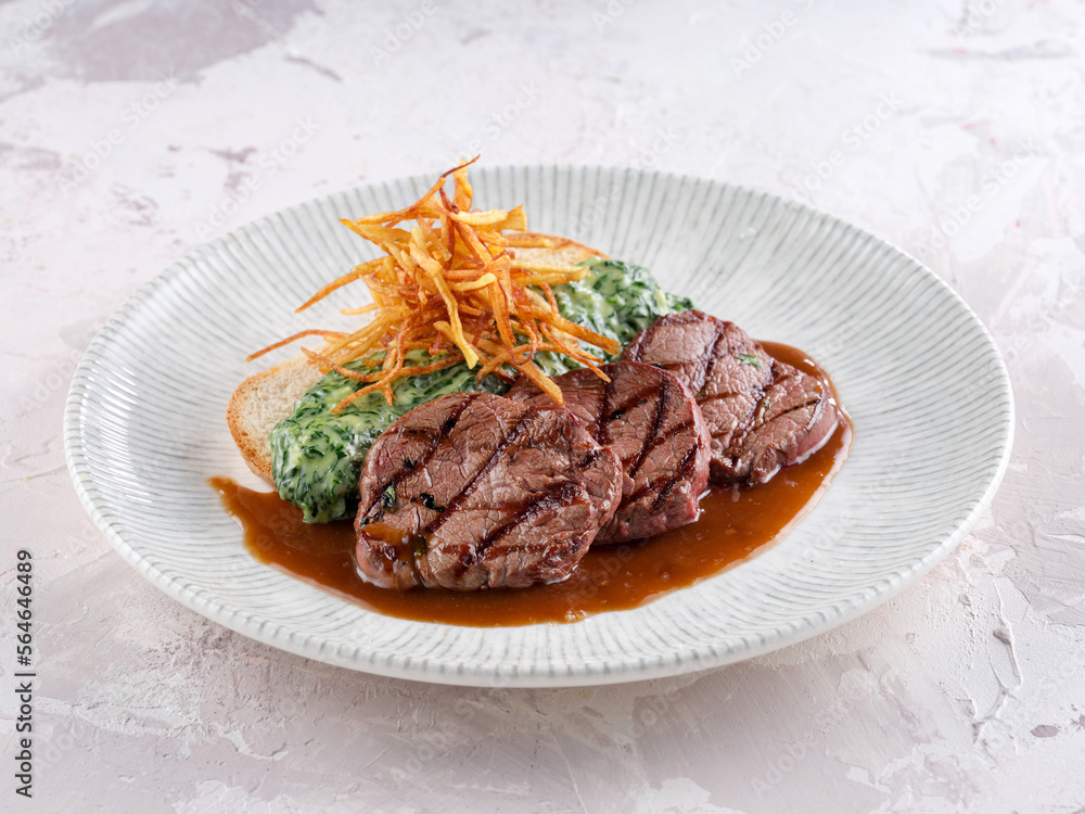 BBQ grilled veal calf brisket meat on short spare rib on wooden cutting board. Dark wooden background. Top view. BBQ grilled veal calf brisket meat on short spare rib on wooden cutting board. Dark wooden background. Top view.