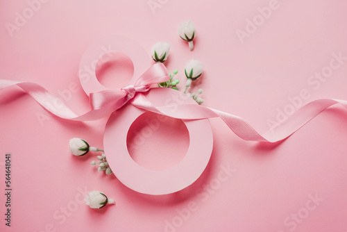 March 8. Paper number eight decorated with spring flowers on a pink background © Evgenia