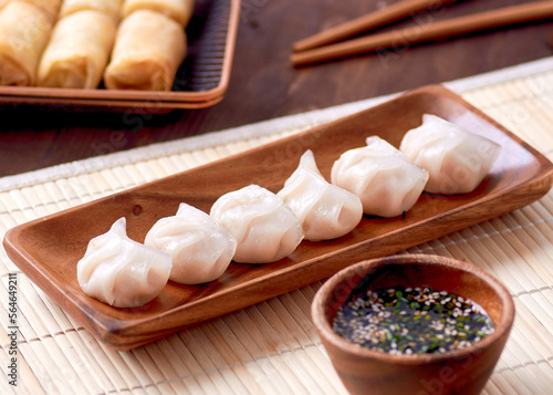 Dumplings at a shared table, Chinese sauce and chopsticks