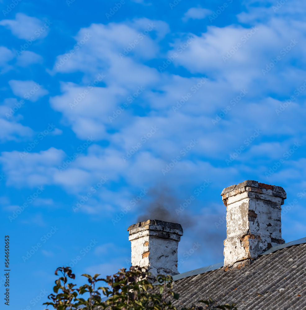 A chimney in a wooden house with black smoke