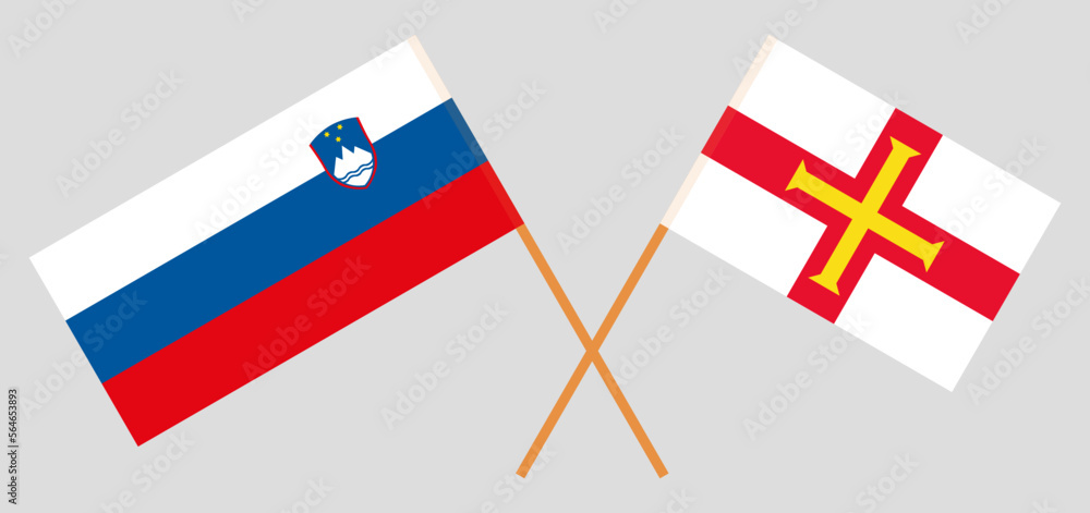 Crossed flags of Slovenia and Bailiwick of Guernsey. Official colors. Correct proportion