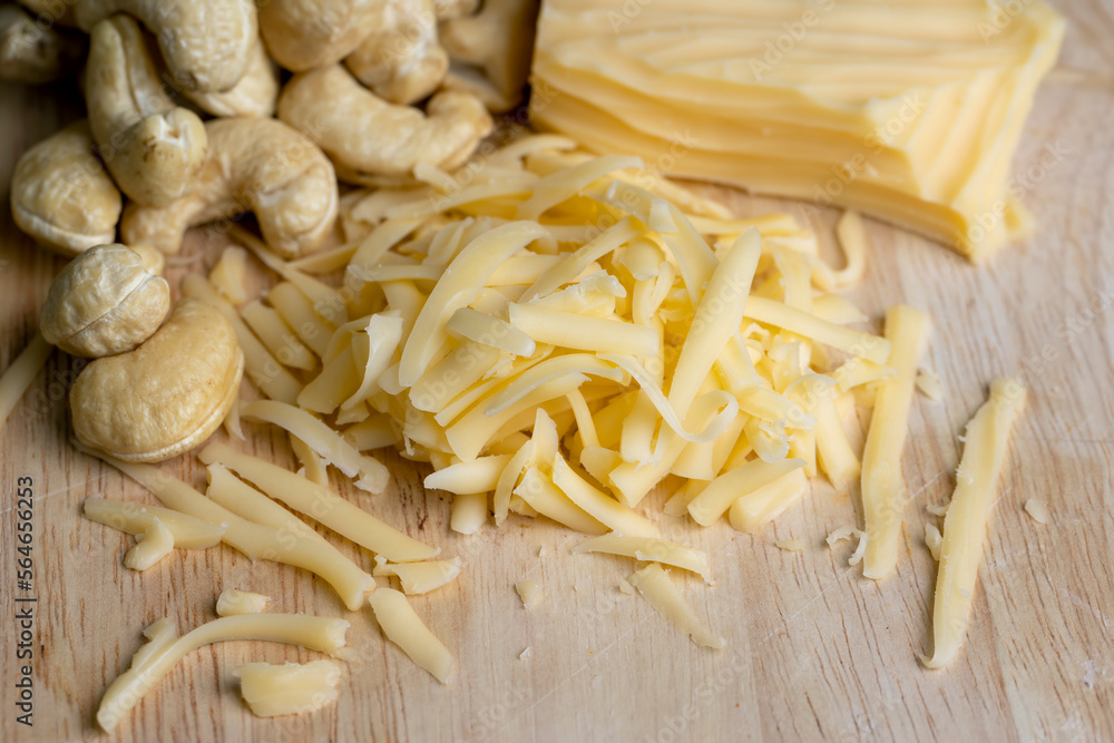 Sliced and grated hard cheese with cashew nuts