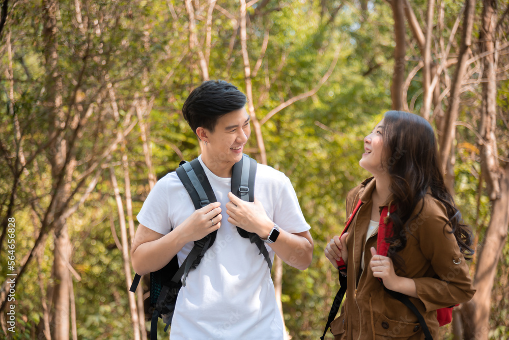 Happy love couple take photo and selfie during camping and relax in forest hiking trip, beautiful Asian woman and handsome man happiness spend time tpgether, sunset liesure romantic moment Happy love couple take photo and selfie during camping and relax in forest hiking trip, beautiful Asian woman and handsome man happiness spend time tpgether, sunset liesure romantic moment