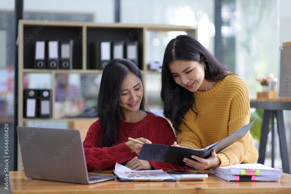 Happy businesswomen colleagues discussing in the office, Planning collaboration and participation of people in the organization. Happy businesswomen colleagues discussing in the office, Planning collaboration and participation of people in the organization.