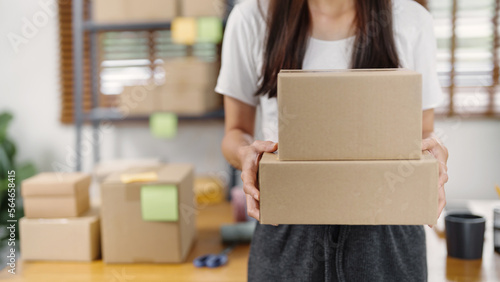 Business owner entrepreneur packing cardboard box preparing parcel for shipment, Online marketing.