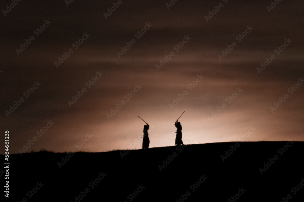 silhouette of two samurai with katana sword