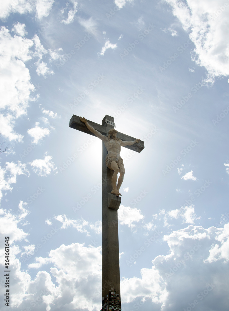 Jesus crucified on the cross with the sky and sun in the background. jesus christ christian