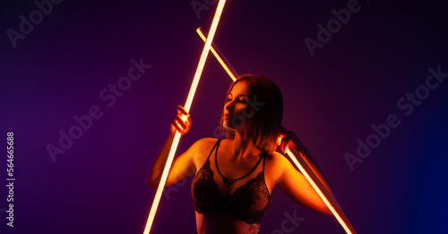 sexy girl in beautiful underwear with neon light on an empty bright background copy paste