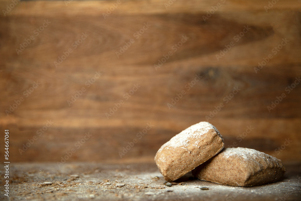 Fresh baked bread with flour on wooden table and background with copy space Fresh baked bread with flour on wooden table and background with copy space
