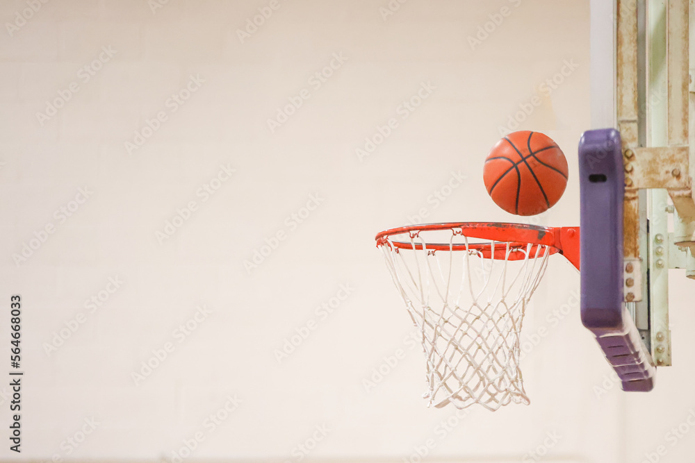 Basketball bouncing off rim and backboard of the hoop. 