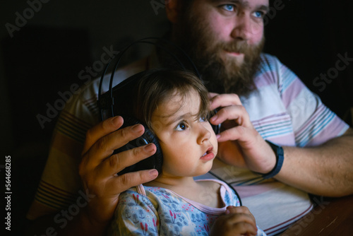 parent and baby listen to music at home or have video chat