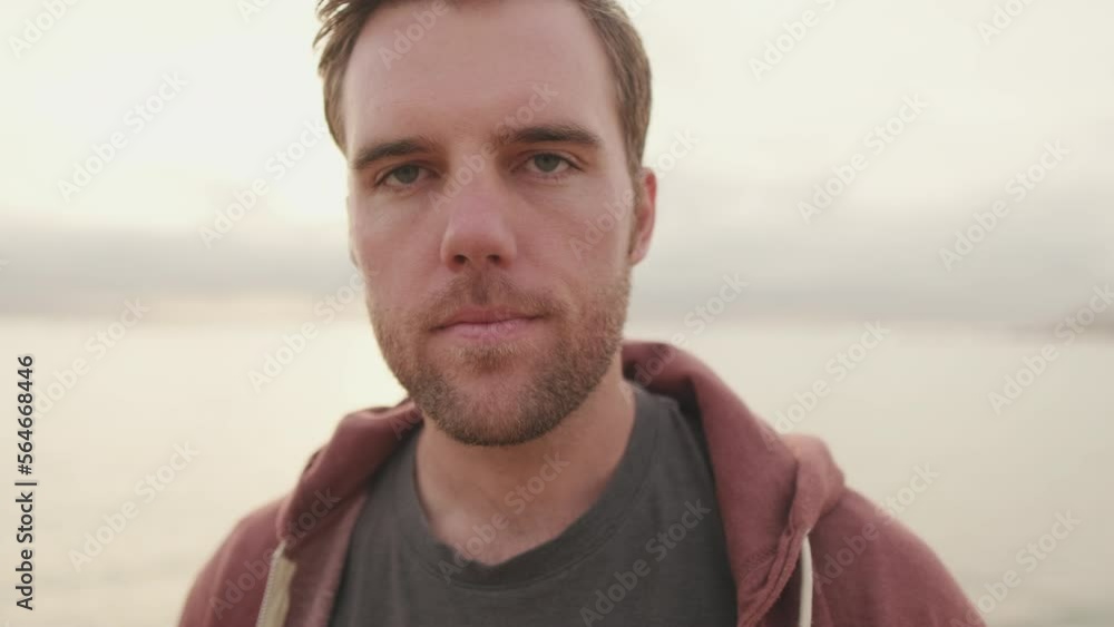 Close-up of young man raising his head and looking at the camera Close-up of young man raising his head and looking at the camera