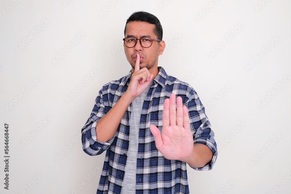 Adult Asian man give stop sign with his hand Adult Asian man give stop sign with his hand