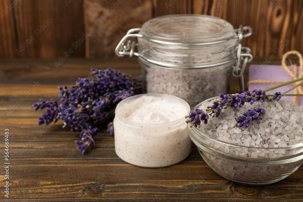 Lavender spa.Cosmetic products sea salt,body cream,handmade soap,scrub,essential oils and lavender flowers on brown wood.Natural herb cosmetic with lavender flowers. Beauty concept. copy space Lavender spa.Cosmetic products sea salt,body cream,handmade soap,scrub,essential oils and lavender flowers on brown wood.Natural herb cosmetic with lavender flowers. Beauty concept. copy space