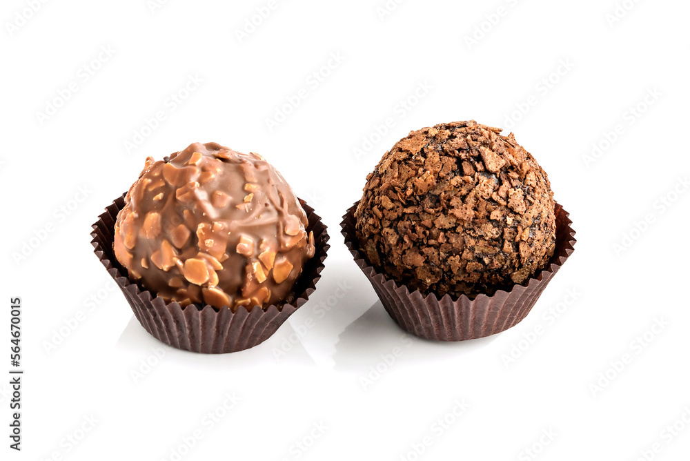 Candies-chocolate truffle with nut sprinkles on a paper base.Isolated on a white background.