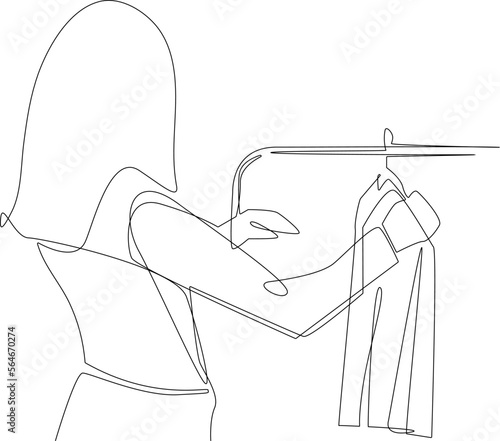 Continuous one line drawing Happy woman standing in front of hanger rack and trying to choose outfit dressing. Clothing concept. Single line draw design vector graphic illustration.