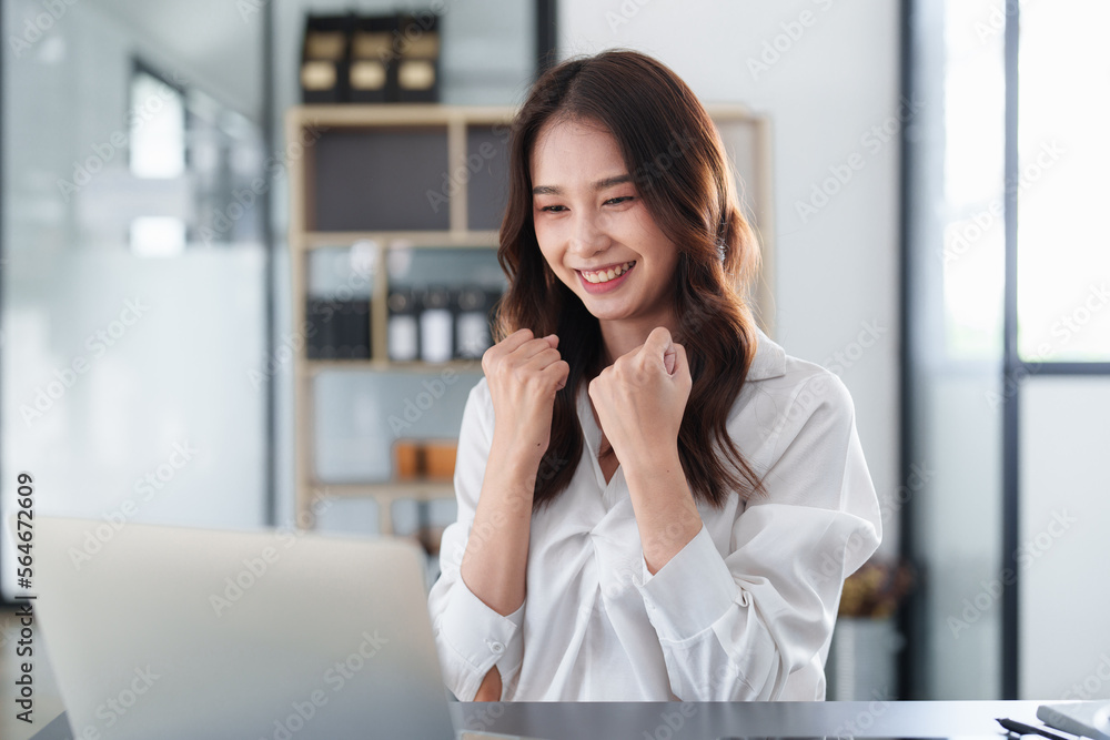 Business people happy to be successful partnership teamwork celebrating achievement and success concept. Beautiful business woman celebrate with laptop Business people happy to be successful partnership teamwork celebrating achievement and success concept. Beautiful business woman celebrate with laptop