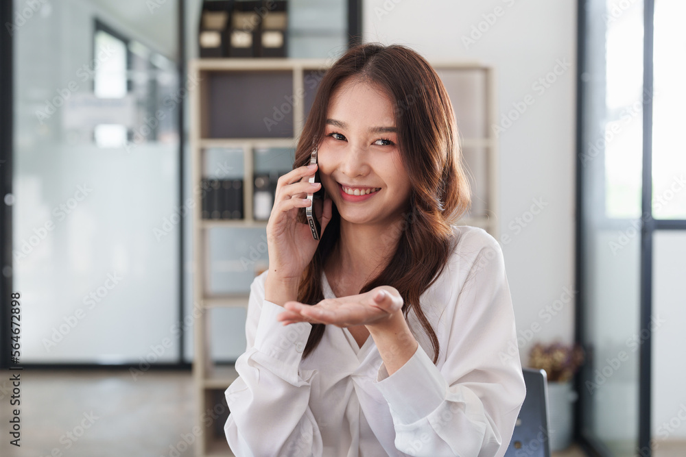Beautiful asian business woman with smartphone in office. Woman in casual at office Beautiful asian business woman with smartphone in office. Woman in casual at office