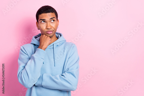 Portrait of minded pensive person hand fist touch chin look empty space isolated on pink color background