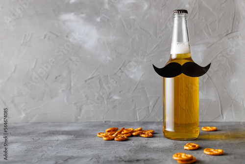 Bottle of beer with moustache. Movember. Concept of father's day, bachelor party.